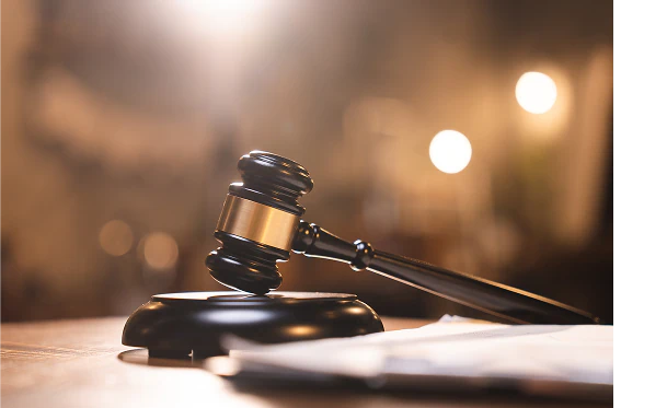 Judge’s gavel resting on a courtroom bench