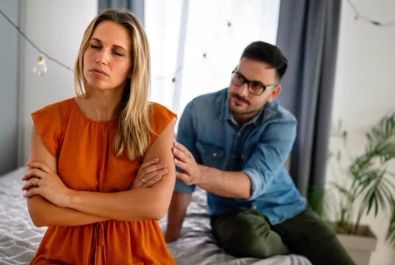 A woman and man sitting apart during a difficult conversation